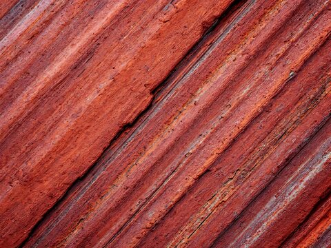 Vibrant Geological Layers A Close-Up of Stratified Red Rock Formation Revealing Earth's Ancient Textures and Natural Patterns in a Rich Earthy Hue