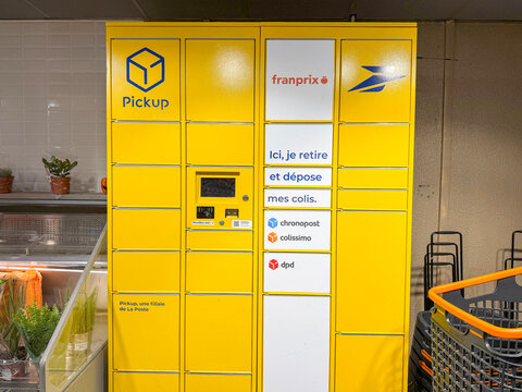 Pickup parcel locker with La Poste and carrier logos in a Franprix store - Rouen, France - September 7, 2026