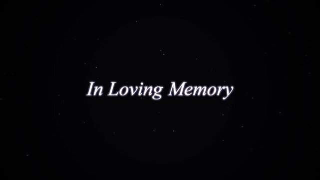 In Loving Memory text centered on a dark textured background with subtle dust particles for memorial tributes.