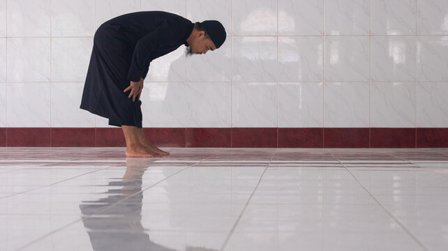 Muslim Man Performing Ruku Prayer in Mosque