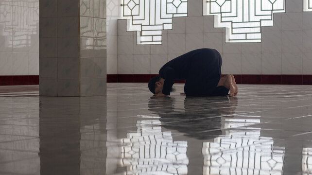 Person Praying in Sujud Position in Mosque Interior