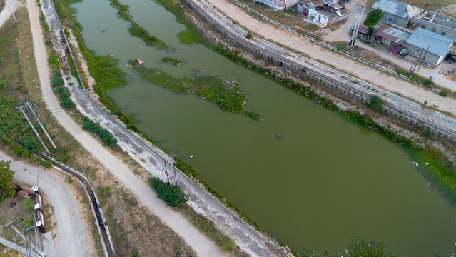 Aerial View of a Green Canal in a Rural Area