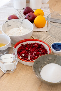Pastry preparation. Home cooking. Set for sweet dough dessert placed on kitchen counter in bowls. Fruit berries healthy treat making.