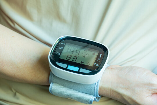 Man check blood pressure monitor and heart rate monitor with digital pressure gauge. Health care and Medical concept	
