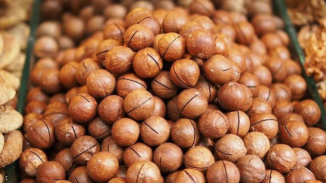 Macadamia nuts in shells displayed for sale at a market