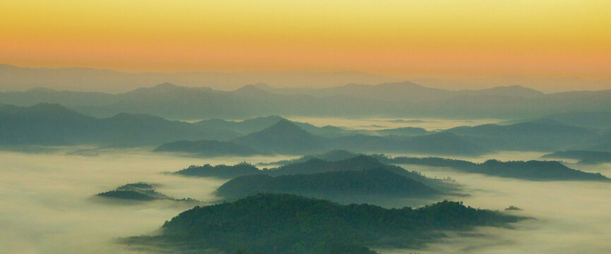 Banner Dramatic sunset mountain landscape. Banner foggy hills sun light time. panoramic Majestic green scenery big mountain hill cloudscape valley panorama view greenery country. Scenic beautiful