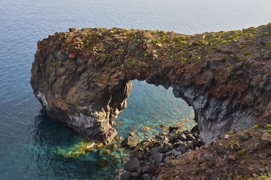 Arco naturale di punta perciato, Pollara Bay, Salina island, impressive rock arch over crystal clear water on a rocky coast, UNESCO World Heritage Site, Aeolian Islands, Aeolian Islands, Sicily, Italy