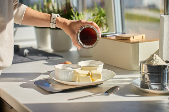 Woman preparing honey and ingredients for home baking