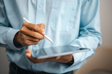 Productivity with planning, technology, digital, and office. A person writes with a stylus on a handheld tablet. The objects frame mobile digital planning as a clear productivity subject. © Garun Studios