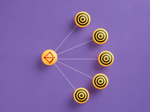 Archer bow aiming multiple targets on purple background