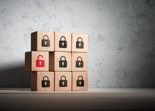 Data security breach with open padlock on wooden block