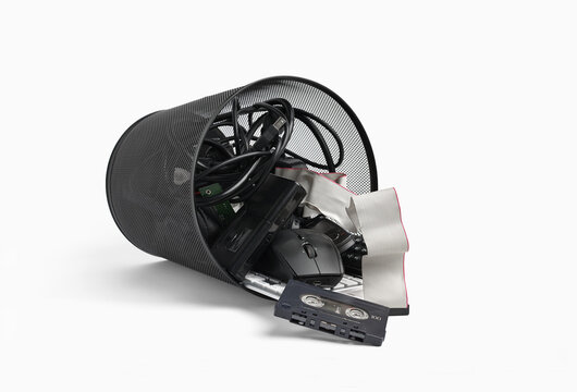 Electronic waste spilling from bin representing pollution concept