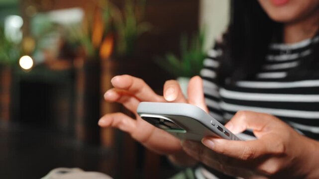 Woman using smartphone at home, texting and scrolling while talking casually, mobile communication, online messaging and digital lifestyle in living room during leisure time and weekend relaxation.