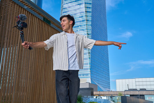 Young vlogger recording video content in madrid city