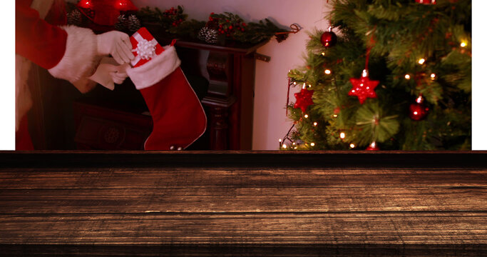 A digital image blends a wooden surface with a festive backdrop of Santa delivering presents.