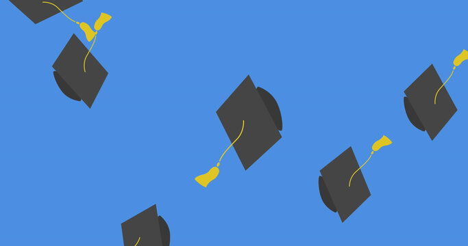 Digital image of multiple graduation hat icons falling against blue background
