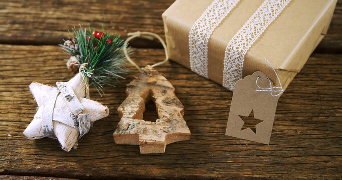 Christmas decorations with star and christmas tree and present on wooden background
