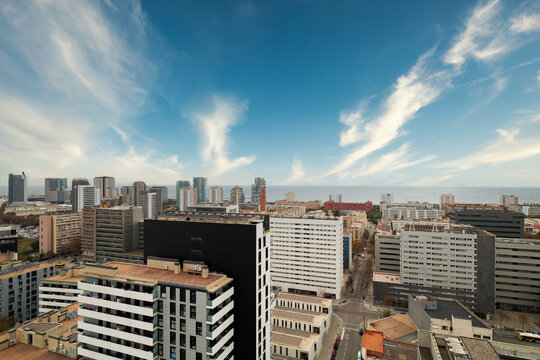 Panoramic modern city skyline with highrise buildings, coastal horizon, glass facades, downtown streets, and clear blue sky above vibrant waterfront metropolis, with city, skyline, highrise