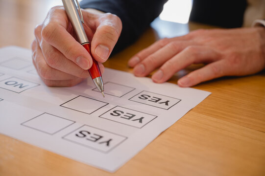 close up and selective focus hand using pen to making tick mark on check list box check list and marker