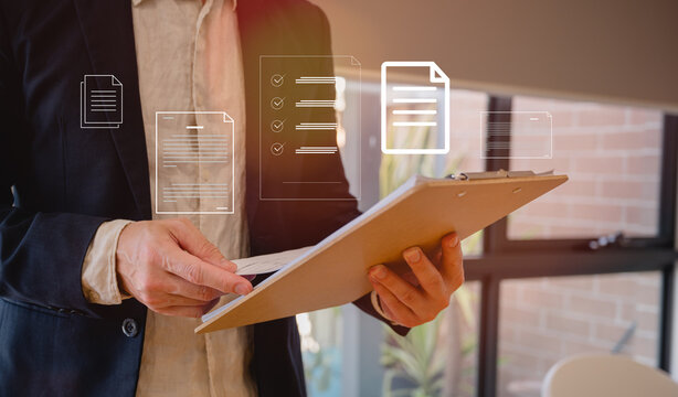 Businessman holding folder of documents in modern office in Business planning and investment financial data analytics graph Financial management technology concept.