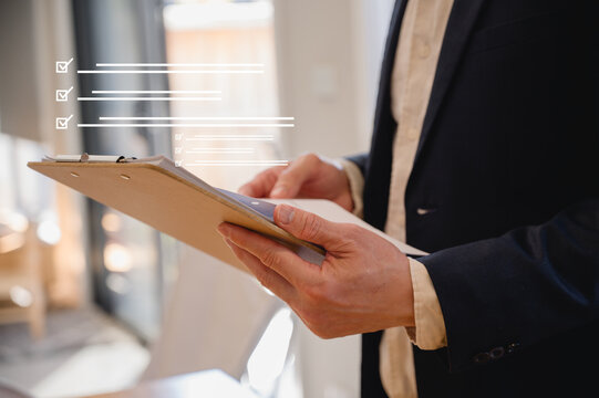 Businessman holding folder of documents in modern office in Business planning and investment financial data analytics graph Financial management technology concept.