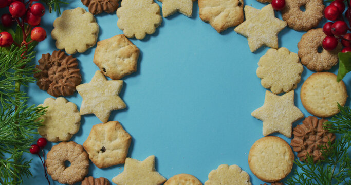 Christmas decorations with cookies and copy space on blue background