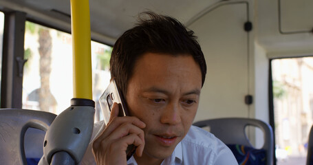 man sitting in city bus talking on smartphone © WavebreakMediaMicro