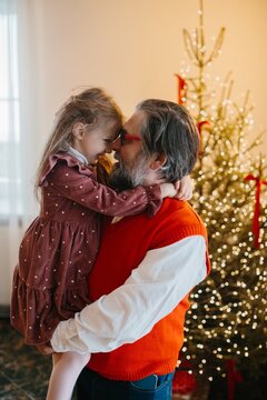 Father christmas hugging happy little girl