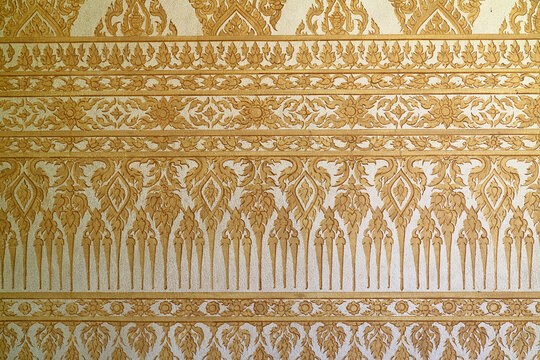 Abstract luxury background featuring historic Thai fine art stencil with antique gold texture