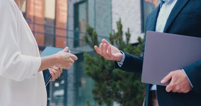 Close-Up of business professionals shaking hands during a business agreement, outdoors