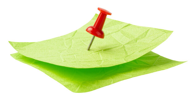 Two crumpled light green sticky notes pinned with a red plastic push pin