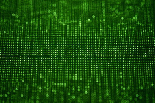 A vibrant green digital matrix or code rain fills the frame, suggesting a futuristic or technological environment.