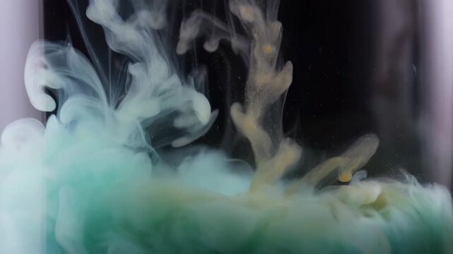 Colored ink clouds billow and diffuse through liquid against a dark background. Title sequences, artistic transitions, and creative advertising.