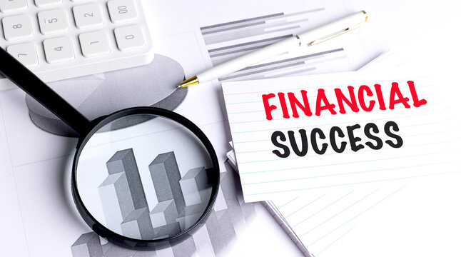 Financial success concept with calculator, magnifying glass, pen and charts, representing business growth and financial analysis