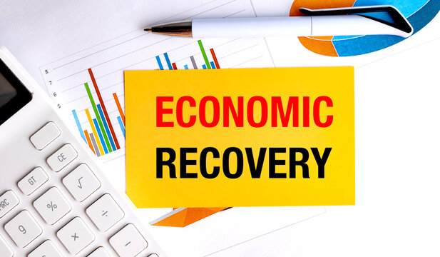 Economic recovery concept with colorful charts, calculator and pen illustrating financial growth and market rebound