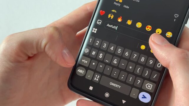 Negative comment in social media with dislike and bad opinion. Thumbs typing awful reaction on smartphone keyboard. Concept of online pressure and stress..