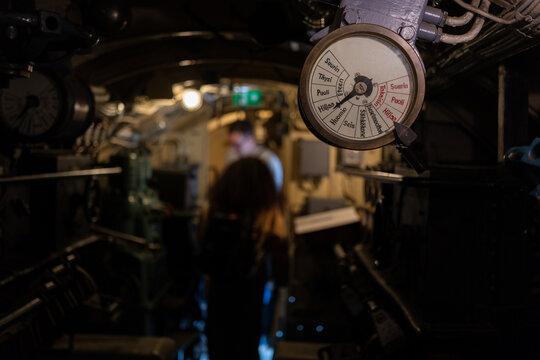 Close-up of a Finnish engine order telegraph in a dimly lit maritime machinery room