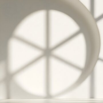 Circular window shadow on a white wall