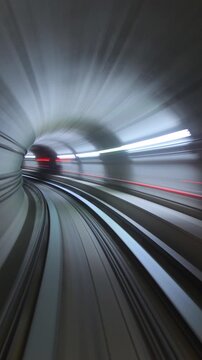 Fast subway train moving through a modern underground tunnel a high speed