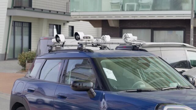 Roof-mounted cameras on a parking enforcement car on a city street traffic control