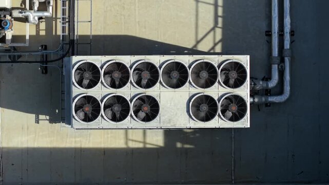 Top down close up aerial view of industrial HVAC ventilation unit with rotating fans in Luton, UK