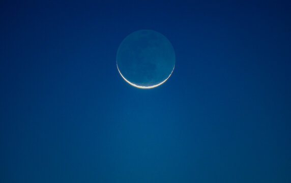 Crescent moon with visible lunar surface