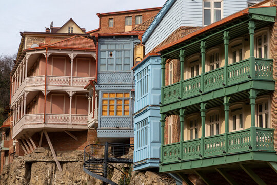 Colorful wooden balconies of historic houses with a spiral staircase, Tbilisi, Georgia