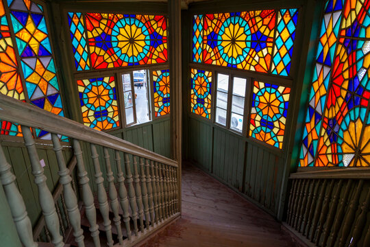 Stained glass windows and wooden staircase inside Kaleidoscope House, Tbilisi, Georgia
