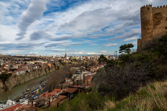 Ancient fortress wall on a hill above the Kura river gorge and old town houses, Tbilisi, Georgia