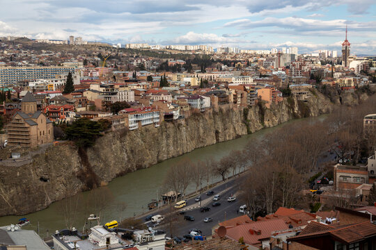 Metekhi Church on the cliff above the Kura river with traffic on the embankment, Tbilisi, Georgia