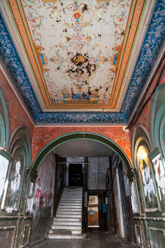 Painted ceiling and staircase in the entrance hall of an old abandoned mansion in Sololaki area, Tbilisi, Georgia