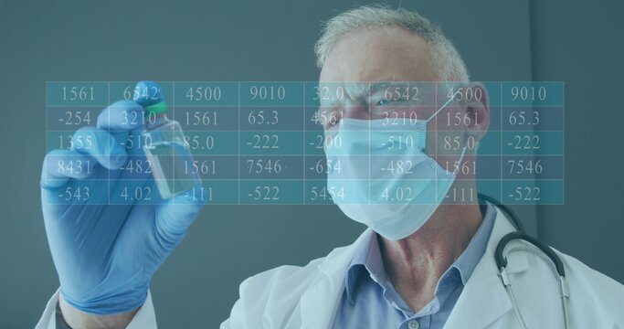 Examining senior doctor holding vial in lab, wearing lab coat, mask, blue gloves, with data grid