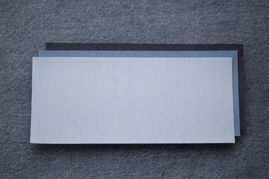 Indigo Denim Textile Background with Overlapping Fabric Swatches and Copy Space