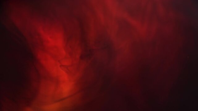 Abstract red smoke pattern in darkness